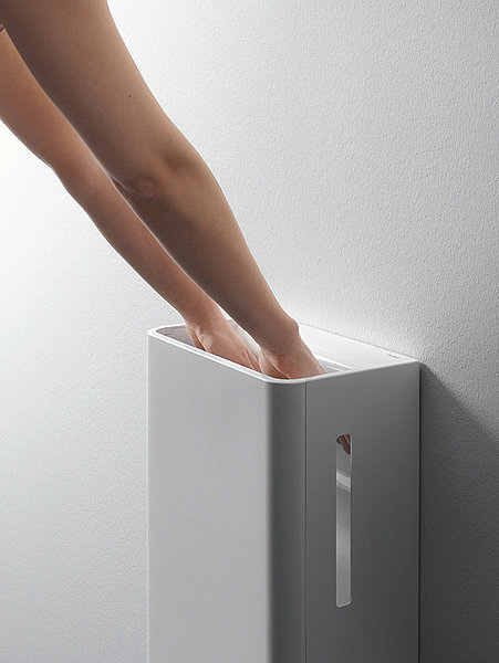 One person uses a TOTO hand dryer
