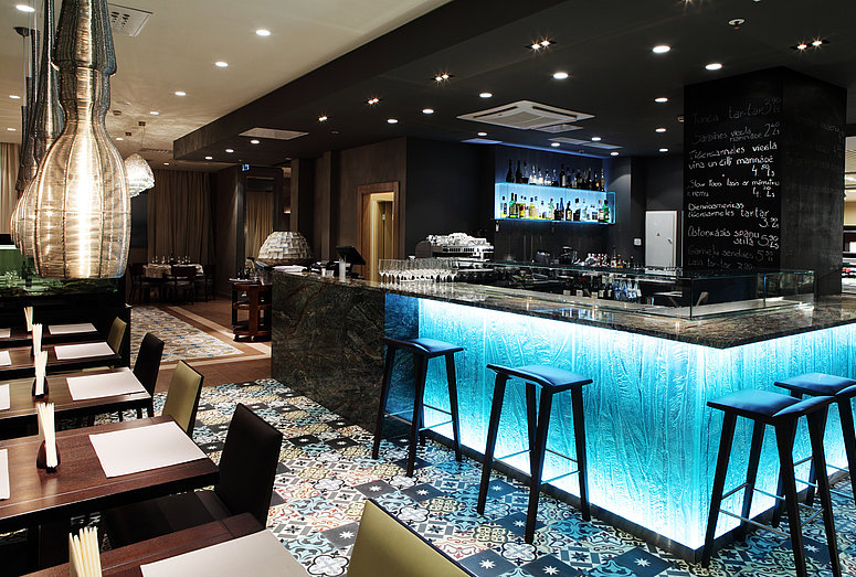 Blue-lit hotel bar at Gastronome Riga Restaurant